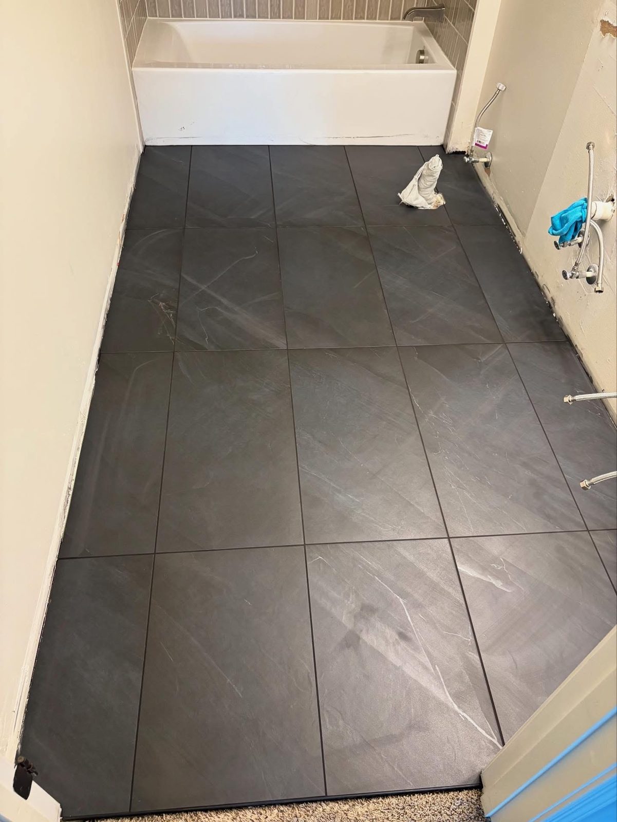 Gray porcelain tile bathroom floor installed in a Dayton, OH home
